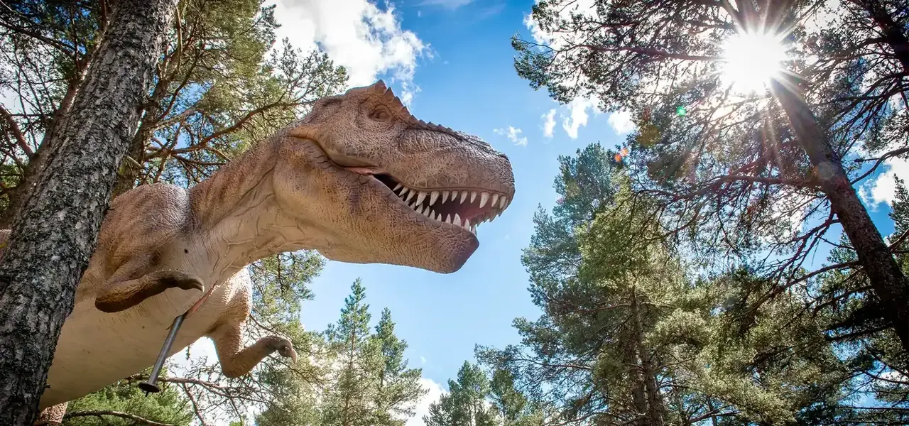 Full-size animatronic T-Rex above a safari track vehicle in the United Kingdom