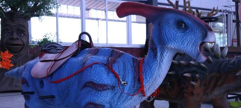 Ride-on animatronic dinosaurs at a theme park