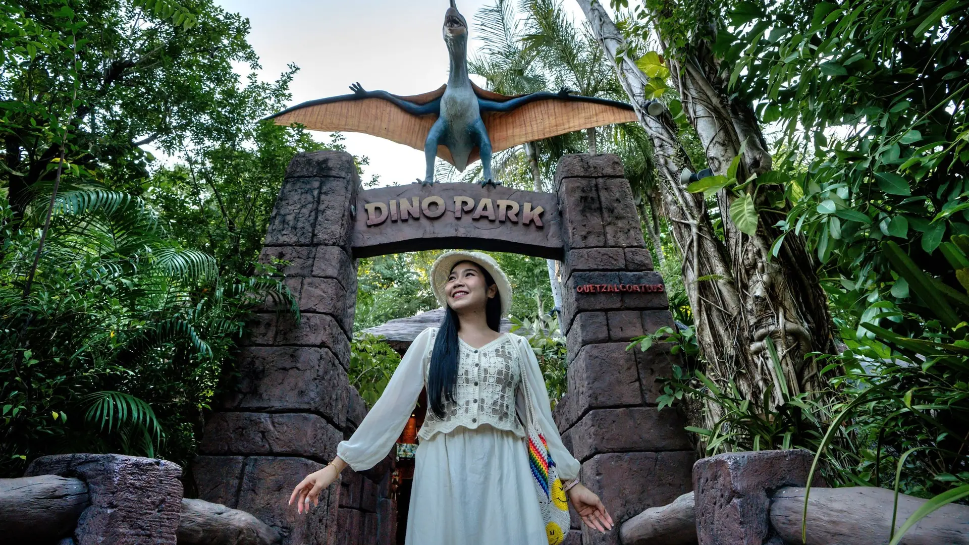 Animatronic dinosaurs installed on an outdoor park trail