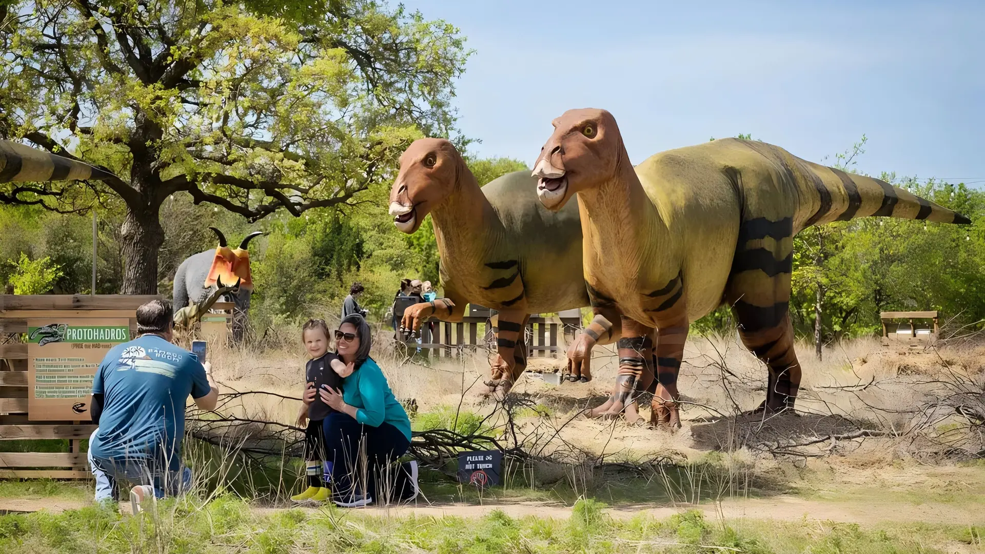 Themed landscaping integrating animatronic dinosaurs into a prehistoric setting