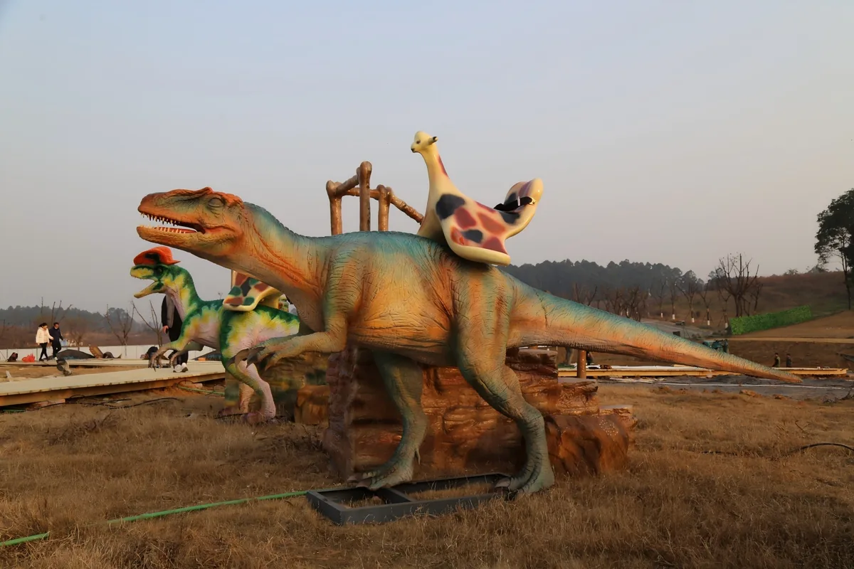 Ride-on Allosaurus animatronic dinosaur in a dinosaur park setting