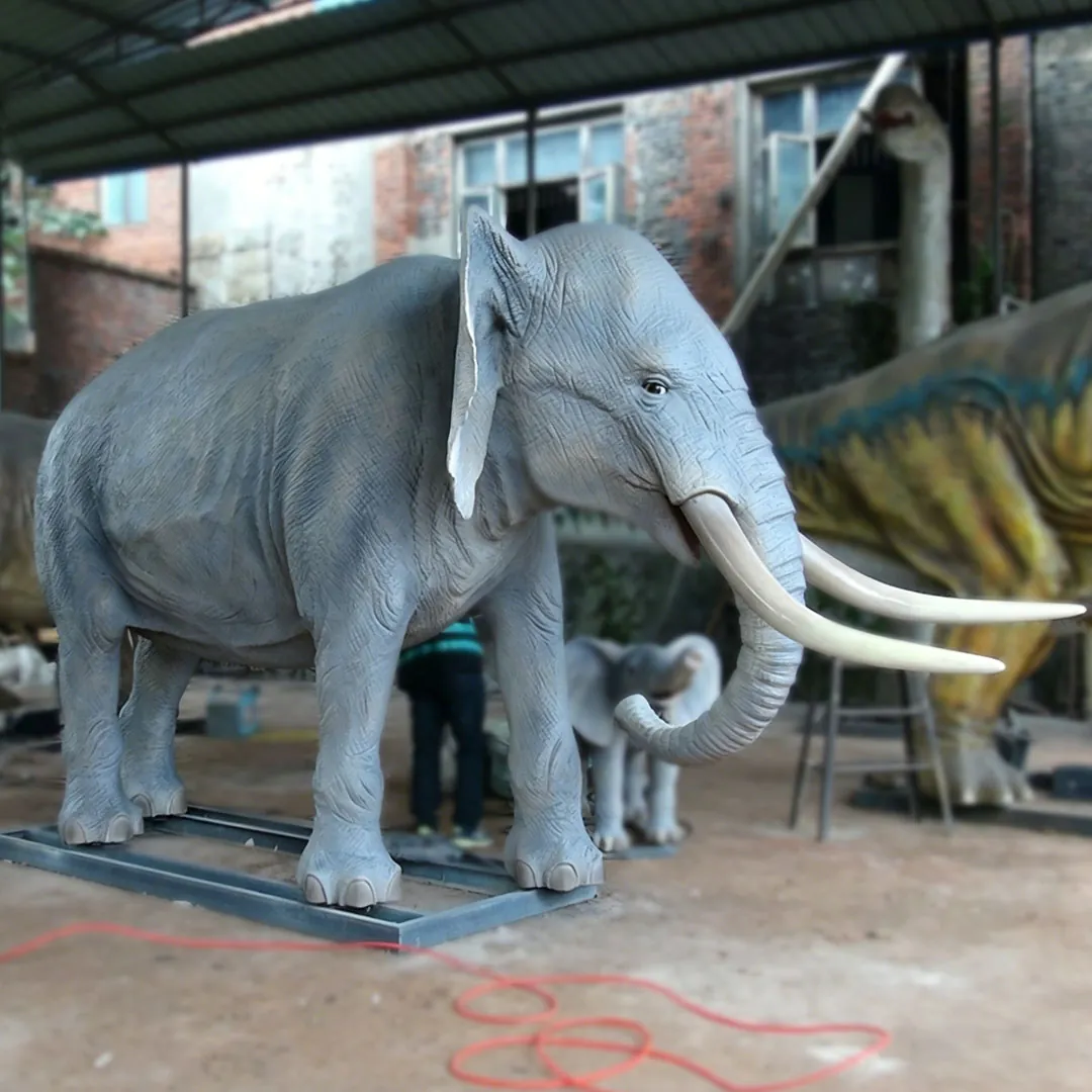 Close-up animatronic African elephant head with large ears, wrinkled skin texture and ivory tusks