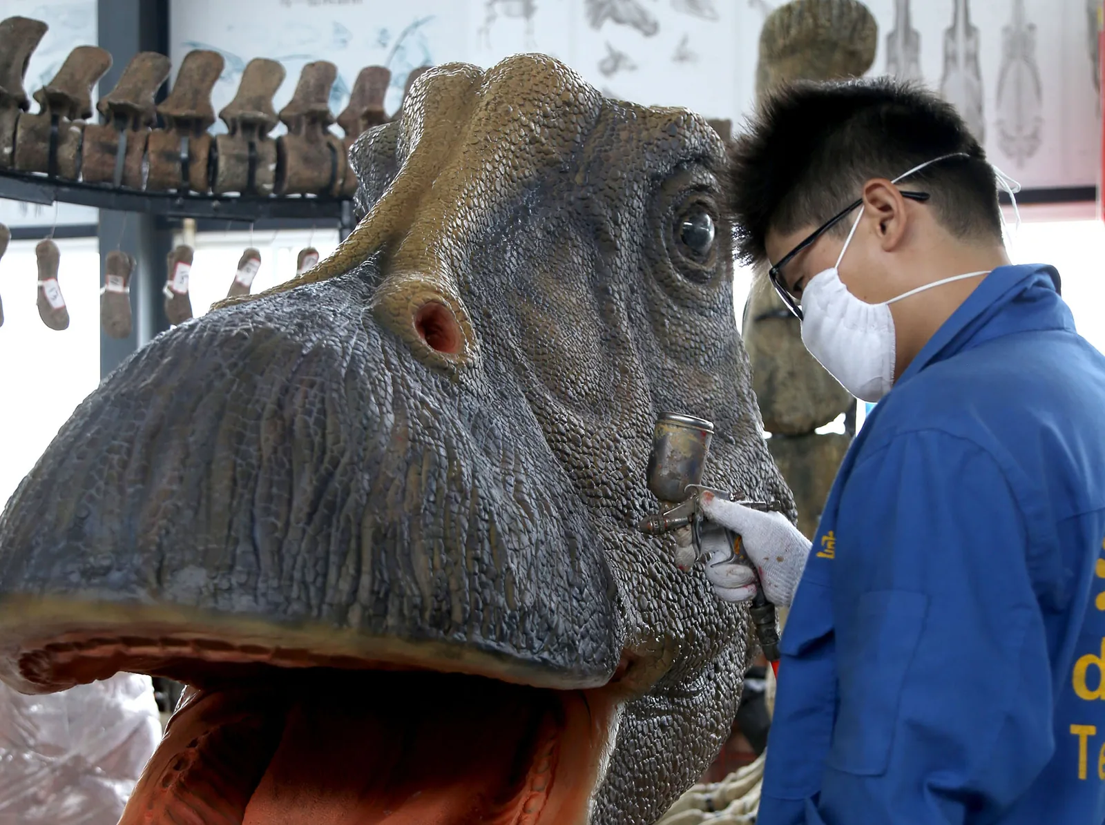 Hand finishing the silicone skin on an animatronic dinosaur model