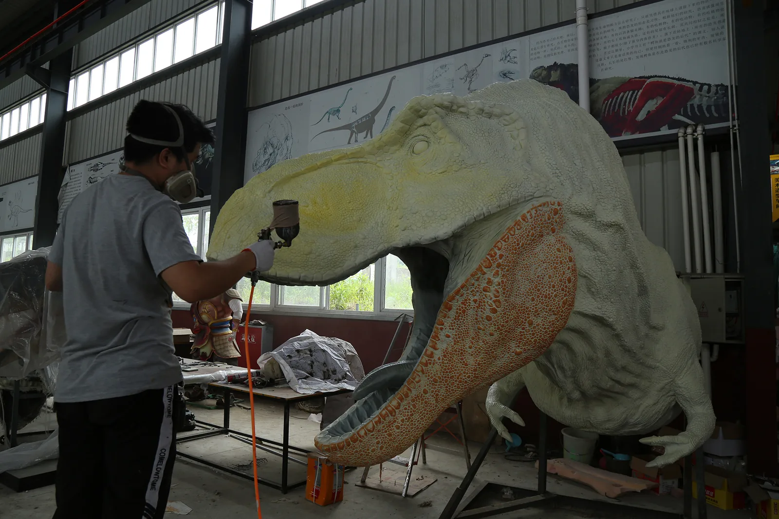 Animatronic dinosaur skin panels being processed on the workshop floor