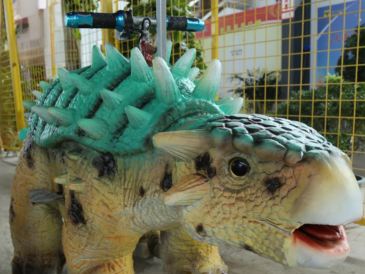 Side view of the ankylosaurus ride unit with the low wide stance and stiffened tail