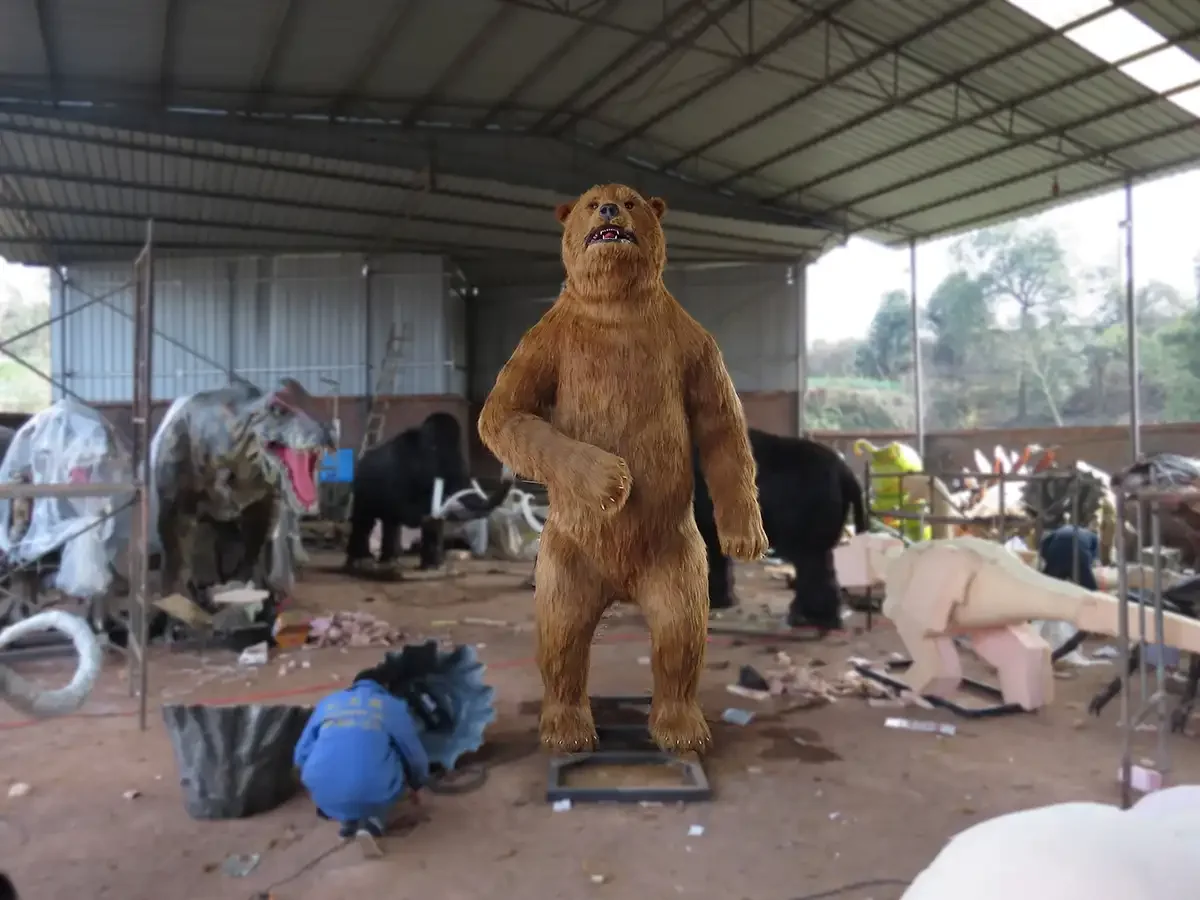 Life-size animatronic cave bear standing on its hind legs showing the domed forehead and shoulder hump