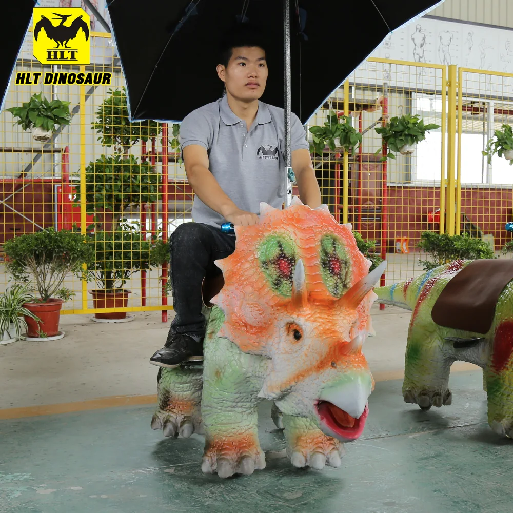 Coin-operated dinosaur ride machine shown from the rear with the seat rails visible