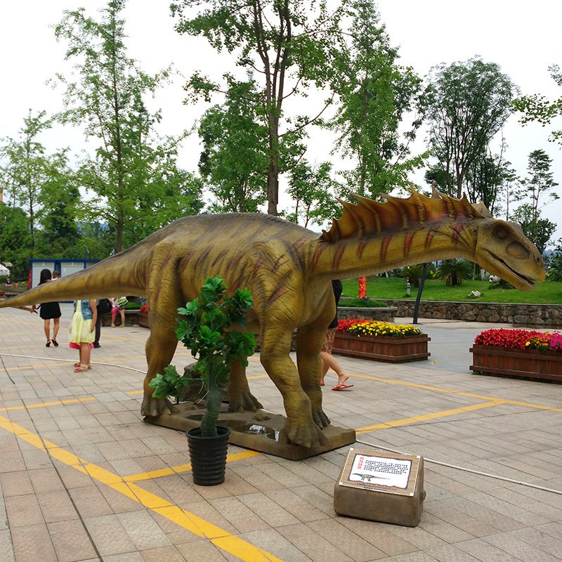 Life-size animatronic Amargasaurus model with tall twin neck spines on display in a public square