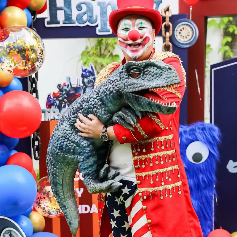 Dinosaur hand puppet with an open jaw held up by a performer