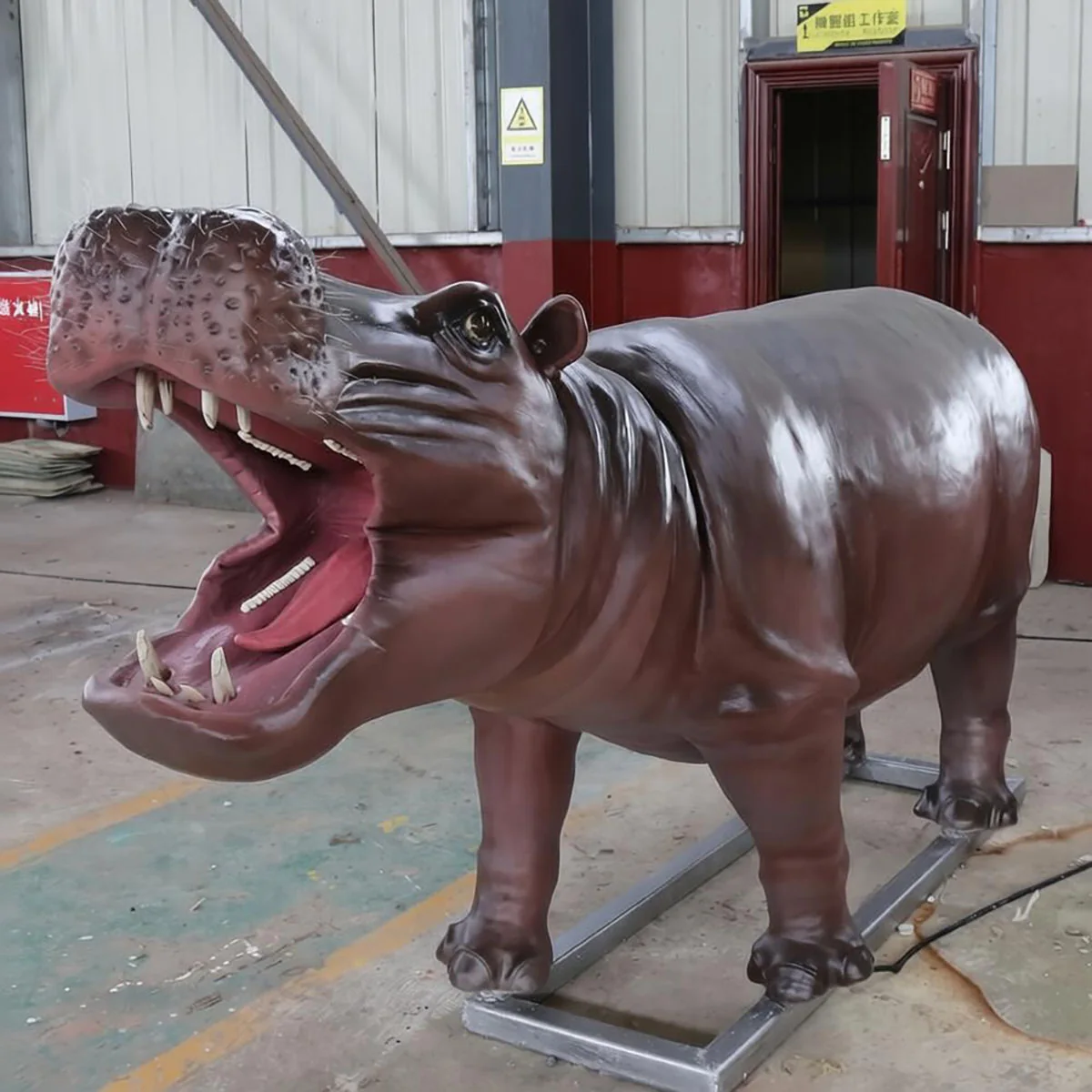 Animatronic hippopotamus head close-up showing jaw and skin detail