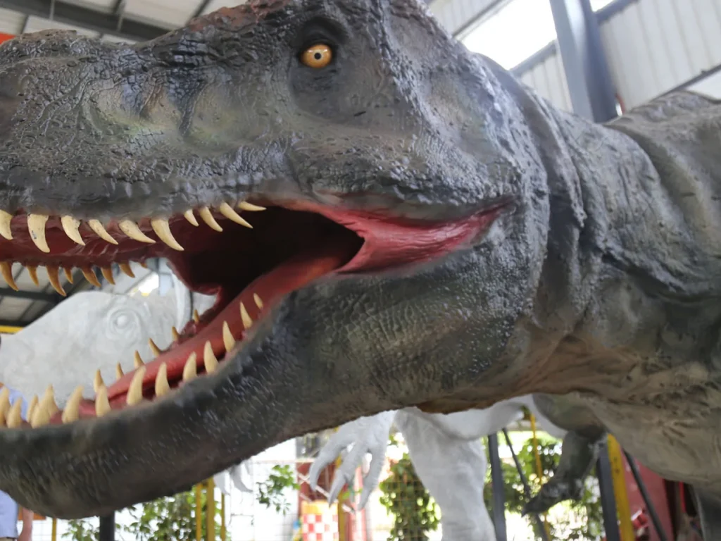 Interactive animatronic dinosaur exhibit responding to a museum visitor.