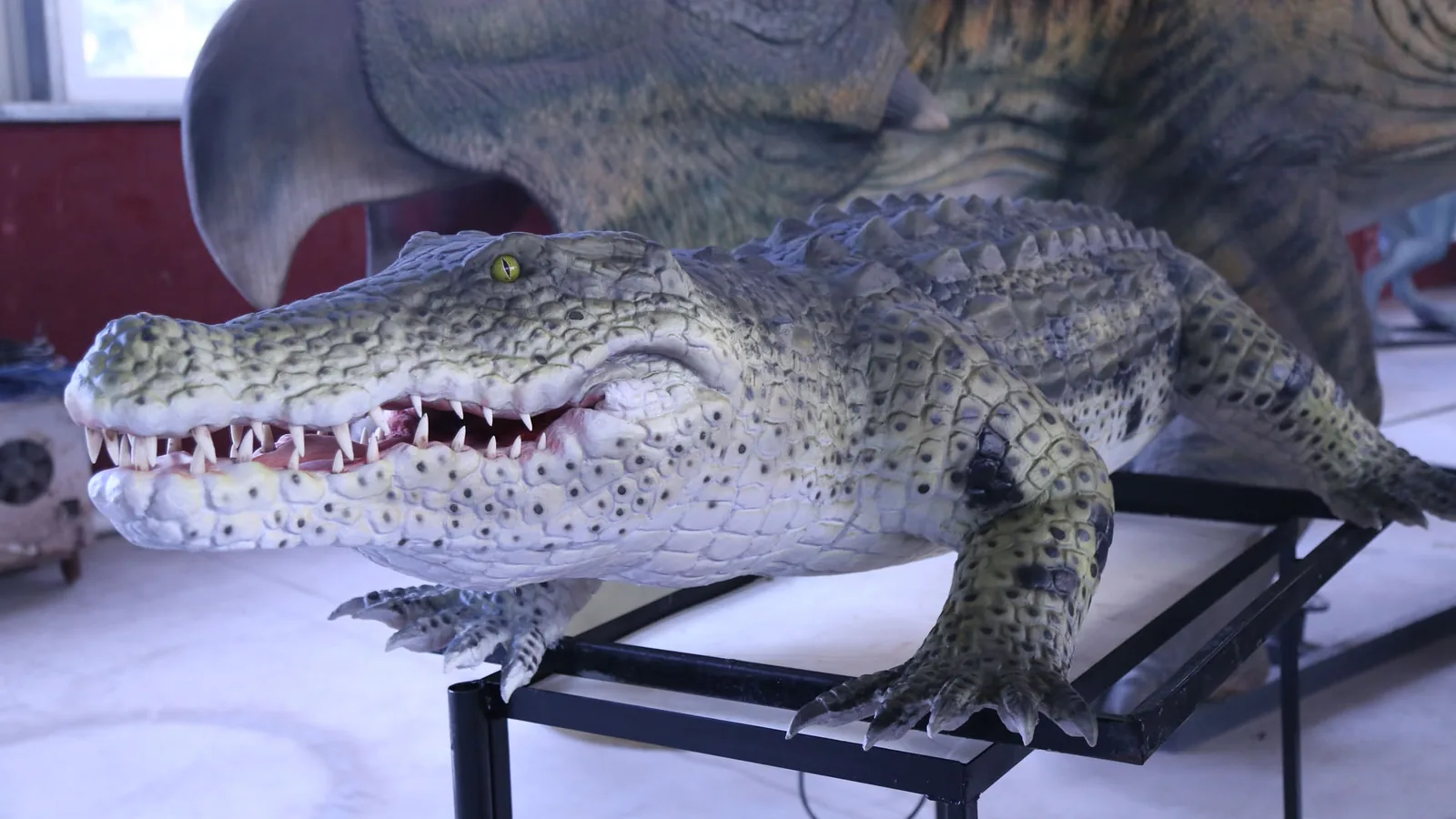 Side view of a life-size animatronic crocodile statue