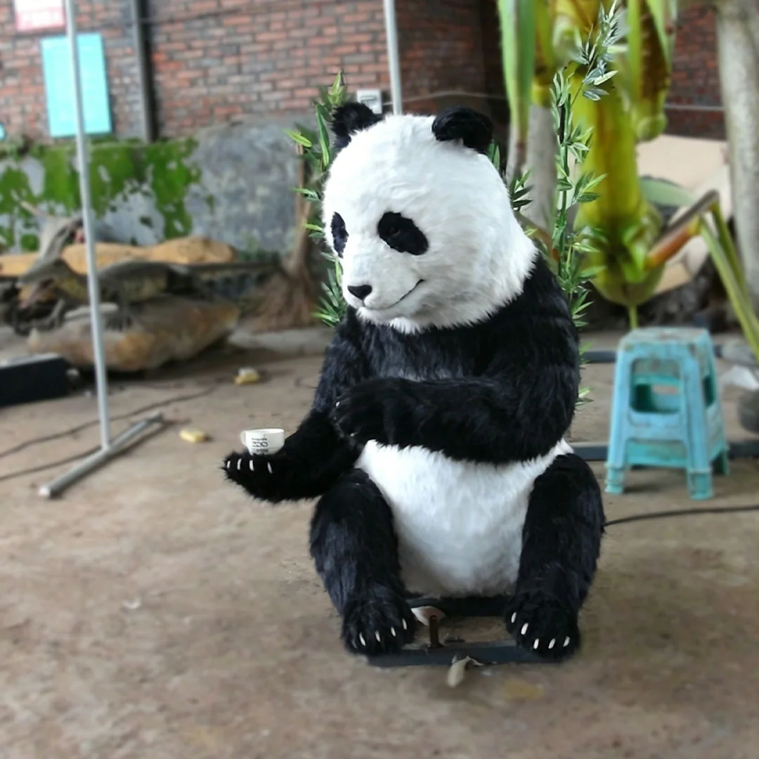 Lifelike giant panda animatronic seated in a tea ceremony pose
