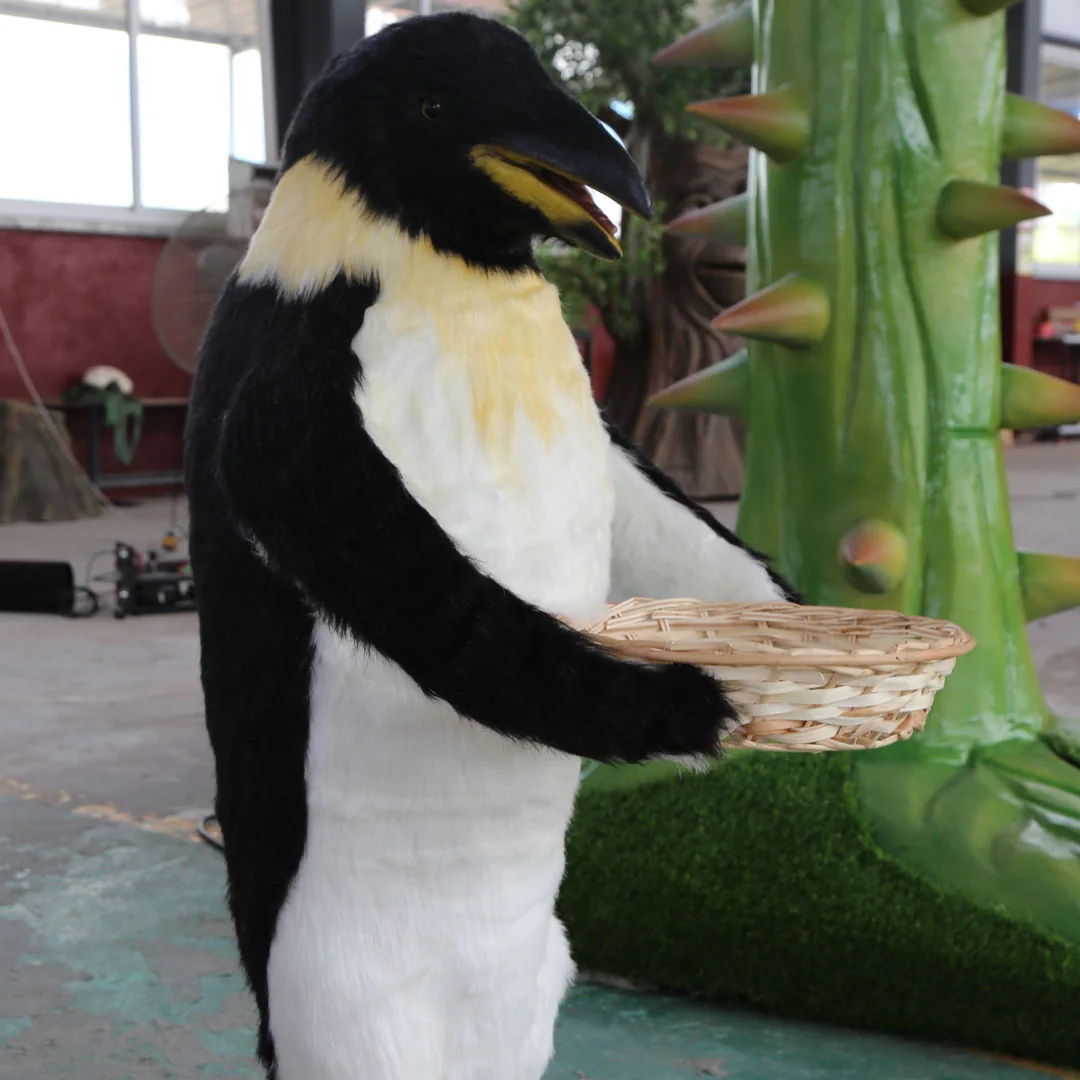 Realistic animatronic penguin with basket prop in a zoo exhibit