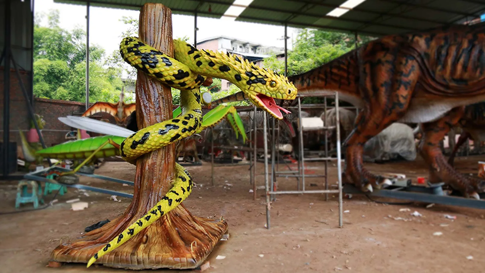 Animatronic python coiled around a branch with open mouth