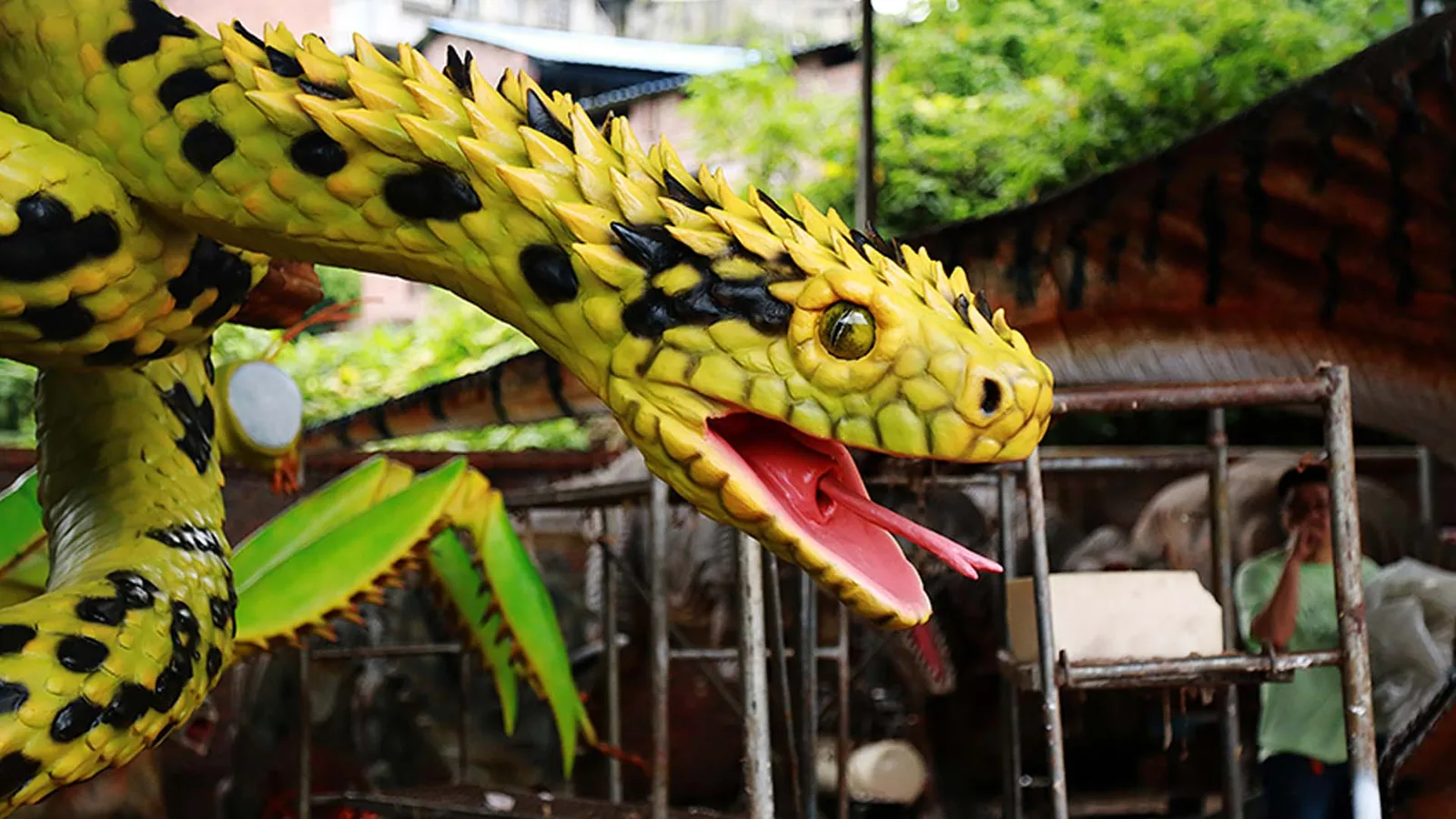 Close view of an animatronic python head with forked tongue