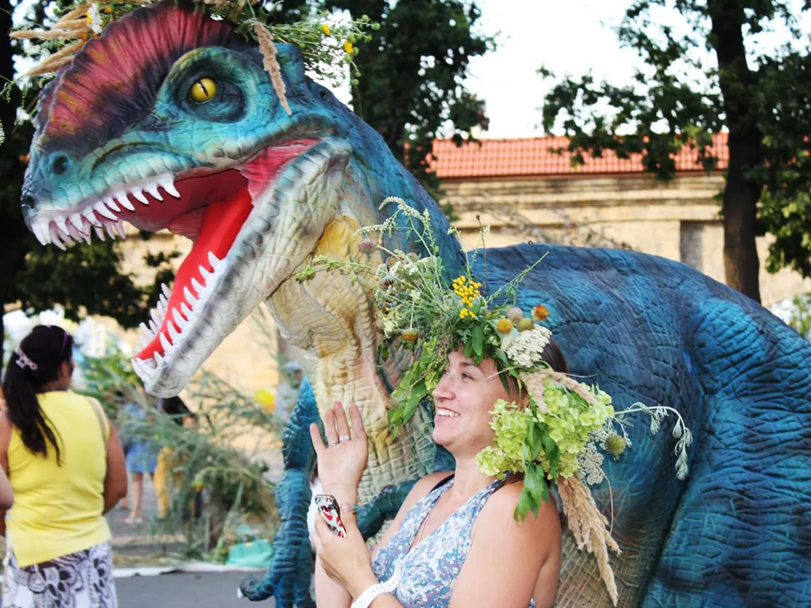 Performer wearing a realistic walking dinosaur costume at an event