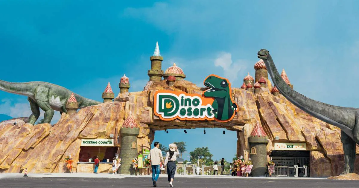 Theme park animatronic dinosaurs at a desert park entrance