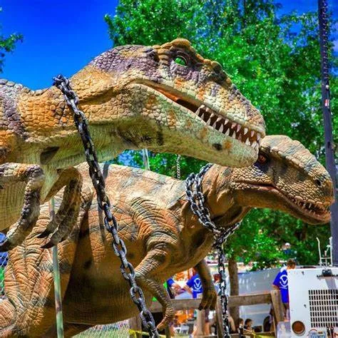Outdoor animatronic dinosaur exhibit on a theme park trail