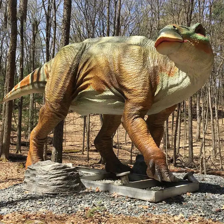 Life-size animatronic Iguanodon in a walking pose showing the conical thumb spike and the beaked upper jaw