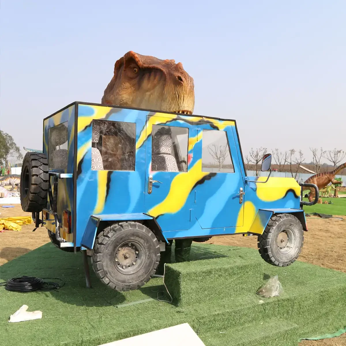 Side view of the interactive T-Rex bites car exhibit showing the T-Rex and vehicle scale