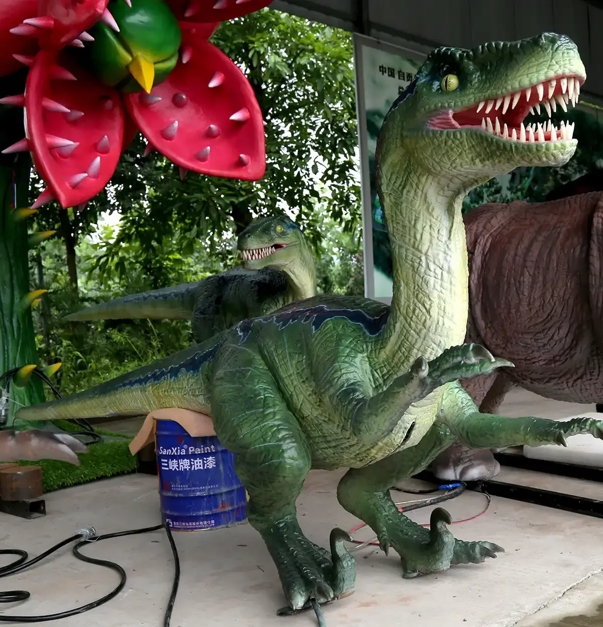 Velociraptor statue front view showing the head, jaws and raised sickle claw