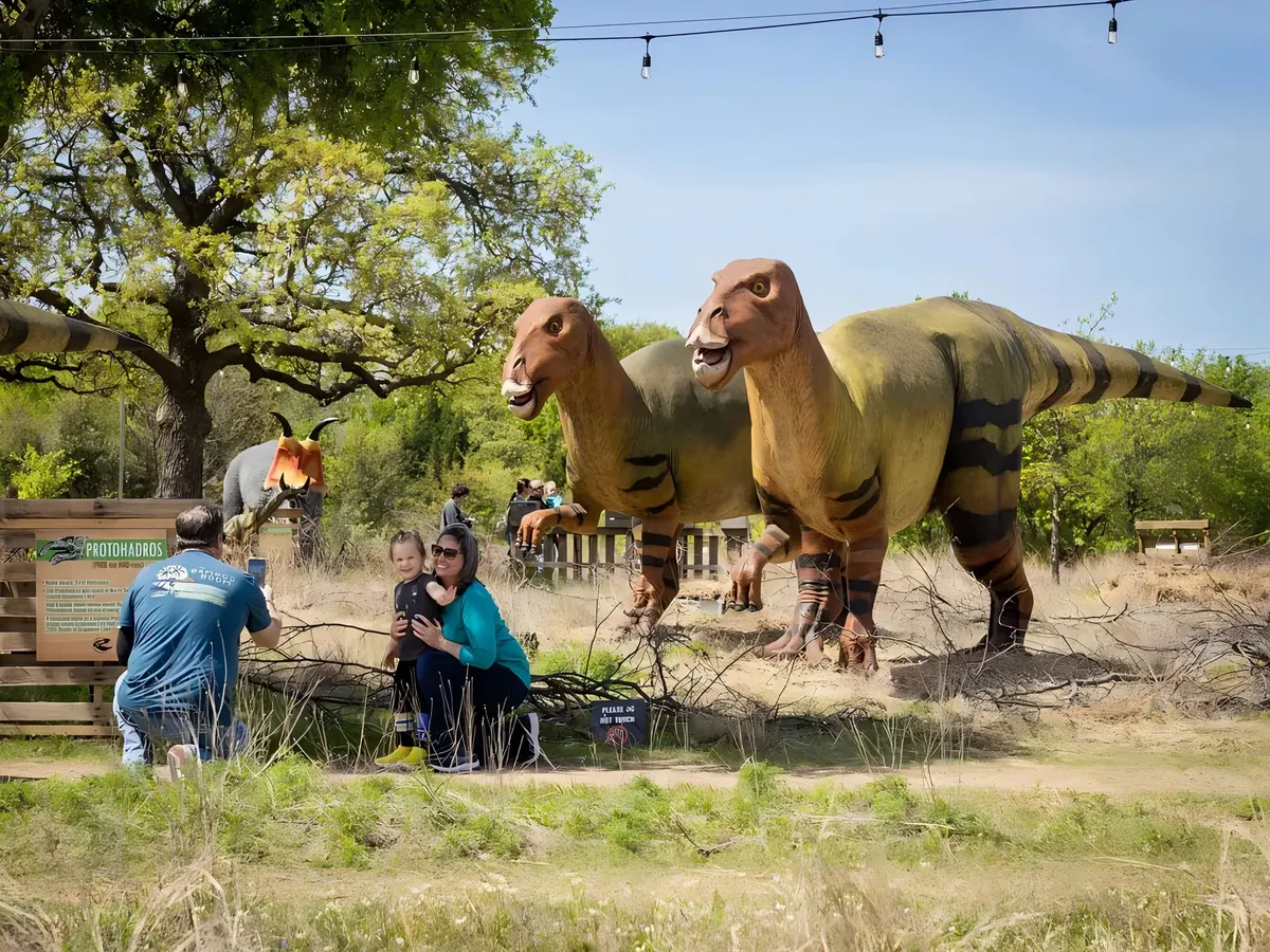 Outdoor zoo animatronic animals exhibit in a prehistoric park